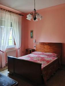 a bedroom with a large bed and a window at Angelini in Lucca