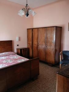 a bedroom with a bed and wooden cabinets at Angelini in Lucca