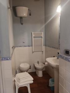 a white bathroom with a toilet and a sink at Angelini in Lucca