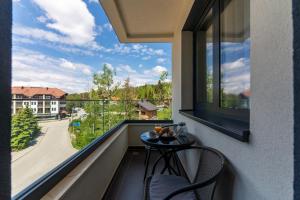 a balcony with a table and a view of a street at Apartman Filipović, Vila Dunav in Zlatibor