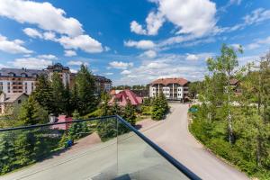 a balcony with a view of a residential neighbourhood at Apartman Filipović, Vila Dunav in Zlatibor