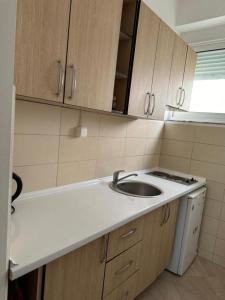 a small kitchen with a sink and a stove at Apartments Sija in Ulcinj