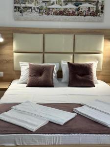 a large white bed with towels on top of it at Apartments Sija in Ulcinj