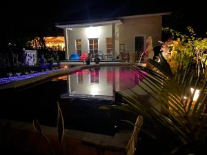 a swimming pool in a yard at night at Villa NiMo Jimbaran in Jimbaran