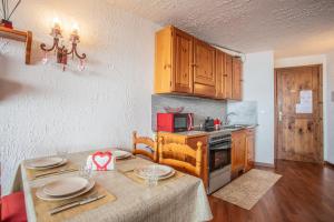 a kitchen with a table with plates on it at Marcolski home in Breuil-Cervinia