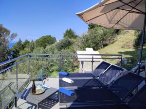 a patio with a table and an umbrella at Villa Orada in Brela