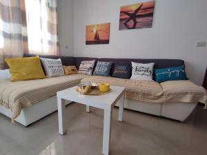 a living room with a couch with pillows and a table at Villa Orada in Brela