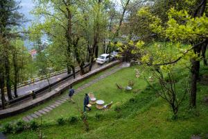 a group of people walking in a park at LOKAL Rooms x Murree Kashmir Point in Murree