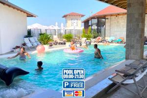 a group of people playing in a swimming pool at Hotel PANORAMA Kruje view on the castle and the old town in Krujë