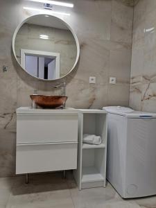 a bathroom with a sink and a mirror at Tabáň Marble apartment (city center & free parking) in Nitra