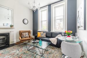 a living room with a couch and a table at Apartment in the James South Neighborhood in Hamilton