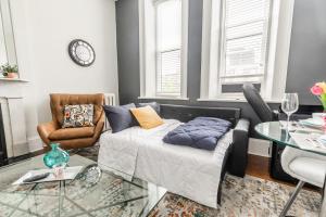 a living room with a bed and a glass table at Apartment in the James South Neighborhood in Hamilton