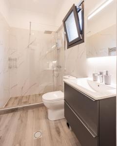 a bathroom with a toilet and a sink and a shower at MonteCasa in Epanomi