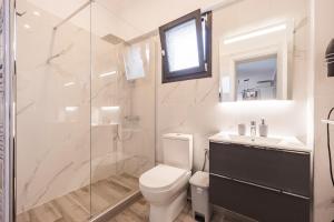 a bathroom with a toilet and a glass shower at MonteCasa in Epanomi