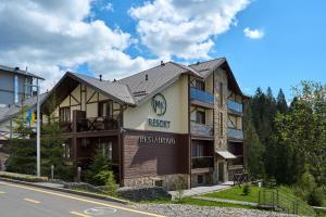 a hotel with a sign on the front of it at MK Resort (ex. Magiya Karpat) in Bukovel