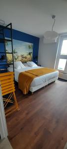 a bedroom with a large bed and a window at Hotel de Champagne in Épernay