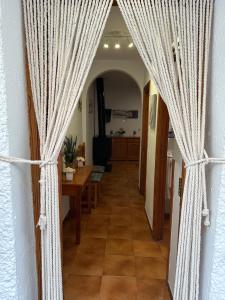 a hallway with curtains in a room with a table at Las Vistas in Bubión