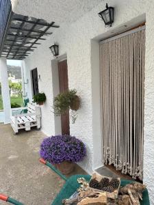 a porch with a large window with purple flowers at Las Vistas in Bubión