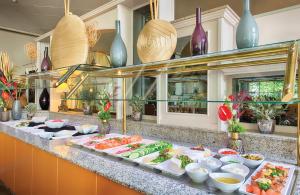 a buffet with many plates of food on a counter at Leonardo Hotel Mannheim City Center in Mannheim