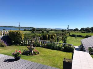 a view of a garden with a fountain and flowers at Seacrest in Galway