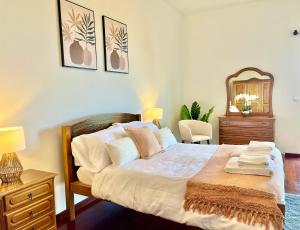 a bedroom with a bed and a dresser and a mirror at Villa Garden Santana by Your Key in Santana