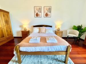 a bedroom with a large bed with two towels on it at Villa Garden Santana by Your Key in Santana