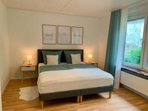 a bedroom with a bed and two lamps on two tables at Apartment Brauselay in Cochem