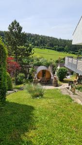 a yurt in a yard next to a house at 'Tor zum Schwarzwald' Ferienwohnungen in Wildberg