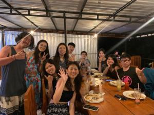 a group of people sitting around a table at Dragonfly Senaru Lodge in Senaru