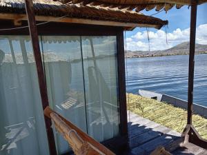 a screened in porch of a house with a view of the water at Q'OTA TAYPY LODGE in Puno