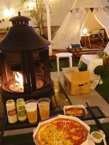 een tafel met een pizza en twee glazen bier bij Hotel Rawa in Seoul