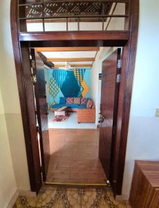 an open door into a living room with a couch at Roof Top Resort in Murree