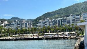 a view of a beach with umbrellas and buildings at Luxury Sea View Apartment in Vlorë