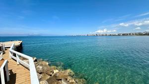 a view of the water with a pier and a city at Luxury Sea View Apartment in Vlorë