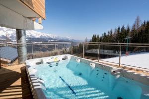 a hot tub on the balcony of a house at Alpenchalets Reiteralm by ALPS RESORTS in Schladming