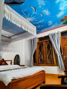 a bedroom with a ceiling painted with a sky at Muong Hoa Hmong Homestay in Sa Pa