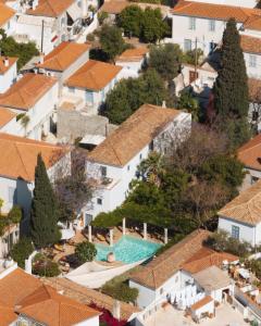 an aerial view of houses and a swimming pool at Bratsera Boutique Hotel in Hydra