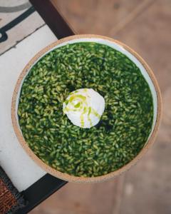 a cup of food with a flower on top of greens at Bratsera Boutique Hotel in Hydra