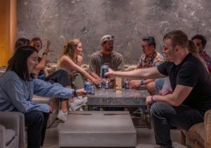 a group of people sitting around a table playing a game at The Millennials Kyoto in Kyoto