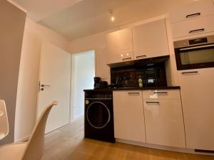 a kitchen with a stove and a washer and dryer at Apartment am Lutherplatz in Potsdam