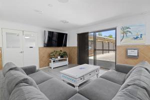 a living room with a couch and a table at Motel Sunshine Coast in Caloundra