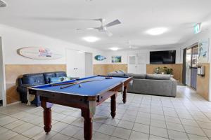 a living room with a pool table in it at Motel Sunshine Coast in Caloundra