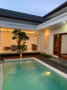 a swimming pool in the backyard of a house at Wikans Villa in Kuta