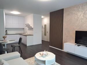 a living room with a couch and a table and a kitchen at Tabáň Marble apartment (city center & free parking) in Nitra