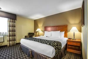 a hotel room with a large bed and a window at Clarion Inn Renton-Seattle in Renton