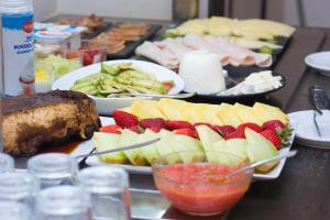 a table topped with plates of food with fruit at Hotel Marfil in San Antonio