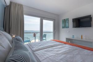 una camera con letto e vista sull'oceano di Beachfront Apartments Zanic a Podstrana