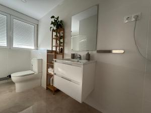 bagno bianco con lavandino e servizi igienici di Tokyo Rooms Monsul Habitación PREMIUM con baño privado a Almería