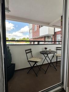 a balcony with a table and a chair on it at Apartment Athens in Sombor