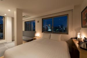 A bed or beds in a room at 9HOTEL Tenjin